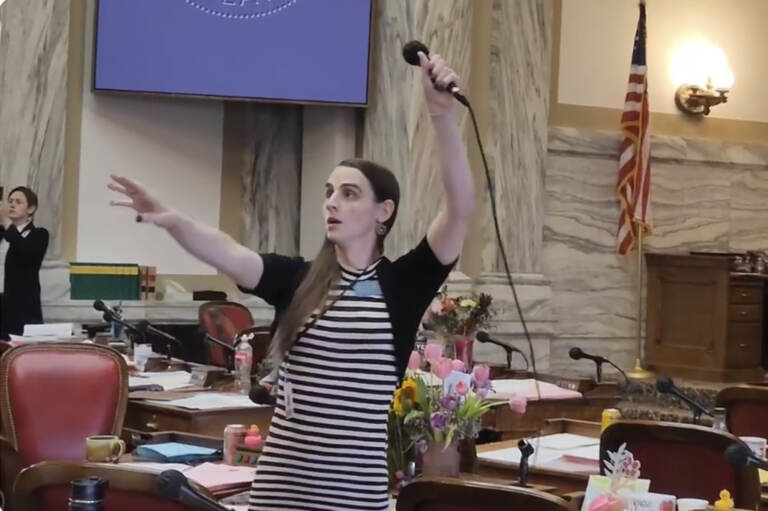 Montana Democratic Rep. Zooey Zephyr hoists a microphone into the air on Monday, April 24, 2023, as her supporters interrupt proceedings in the state House by chanting ''Let Her Speak!'' in Helena, Mont.