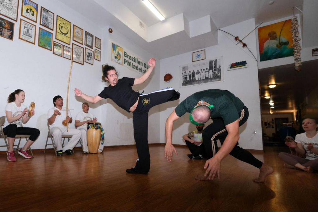 Project Capoeira Ricardo Melendez (right) and Peter DiGeronimo, members of Project Capoeira, throw kicks in the circle, also known as the “roda”.)