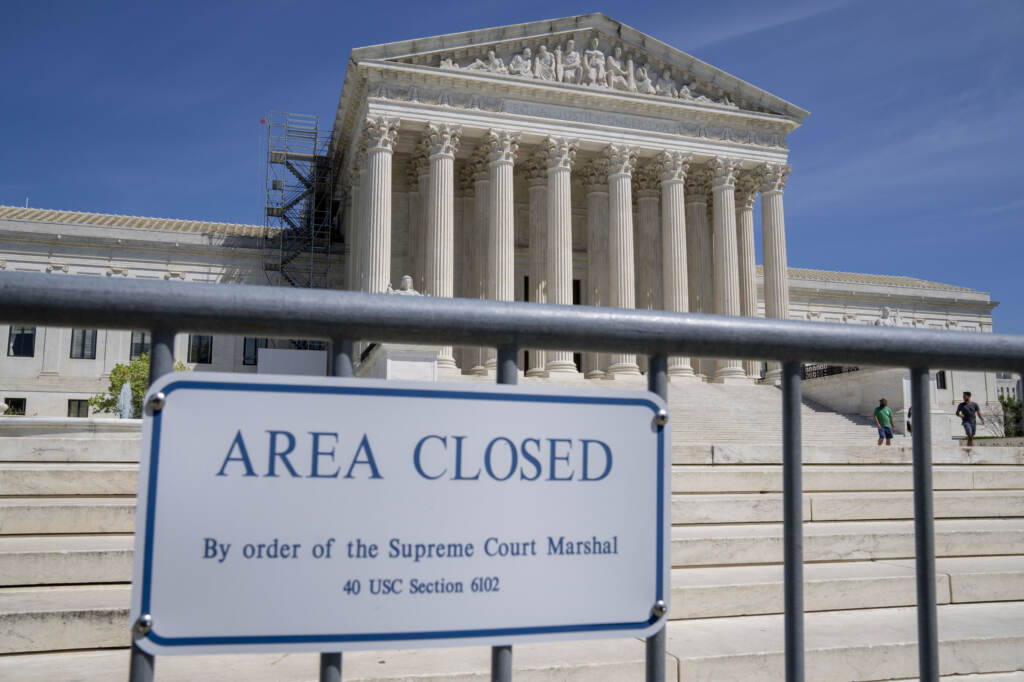 Security fencing is seen as people visit the Supreme Court on April 19. Supreme Court building