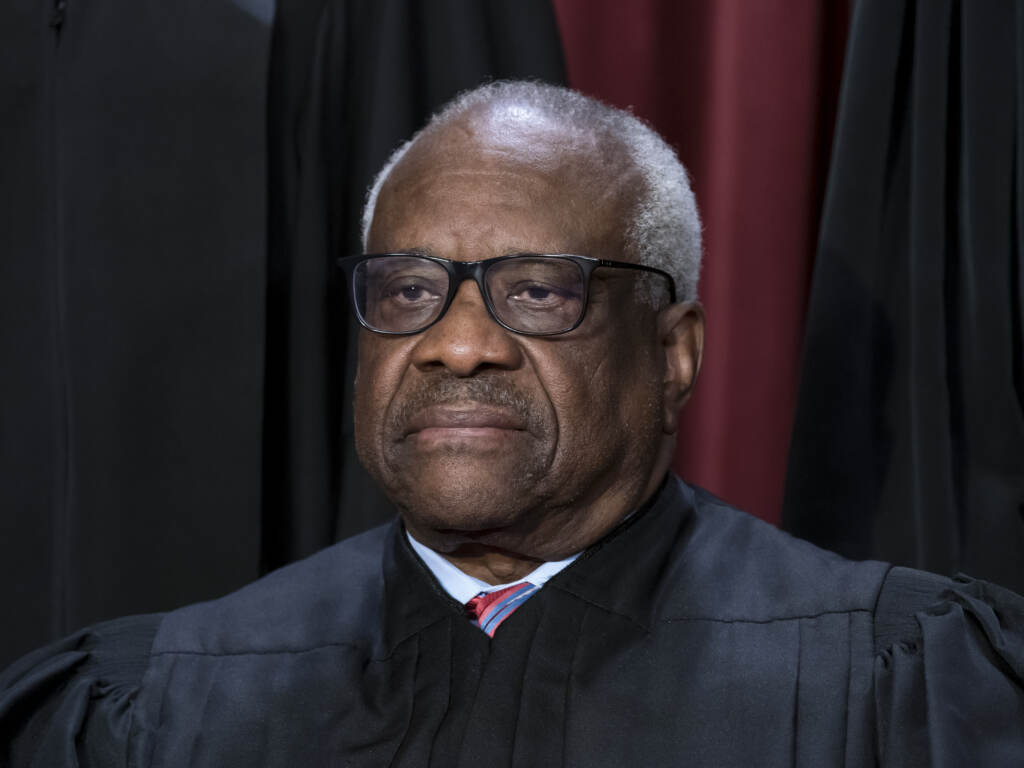 Associate Justice Clarence Thomas joins other members of the Supreme Court as they pose for a new group portrait, at the Supreme Court building in Washington