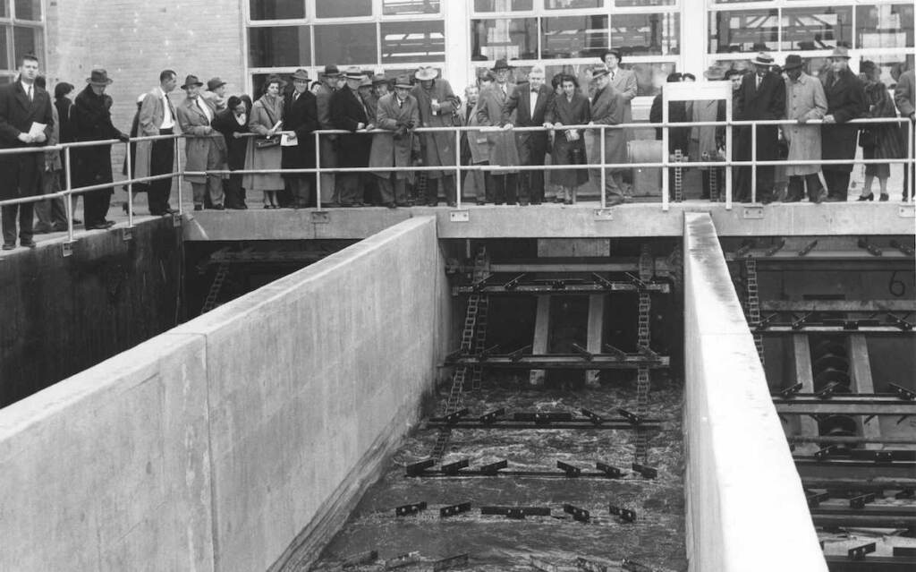 baxter-6 A black-and-white photo of people overlooking a sewage plant.