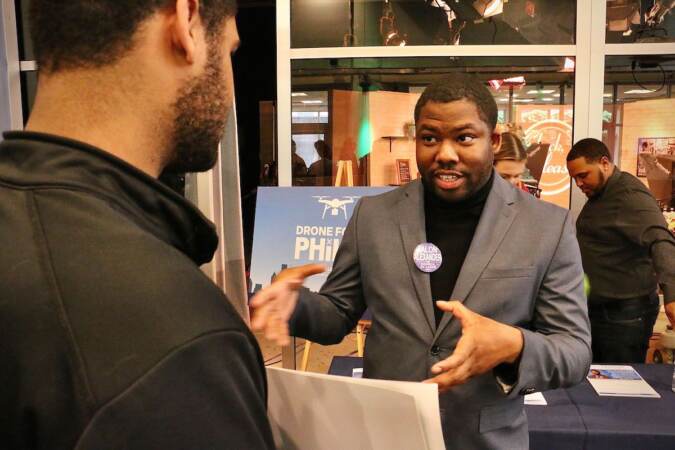 Philadelphia City Council candidate Jalon Alexander talks with voters at a candidate convention hosted by WHYY. (Emma Lee/WHYY)