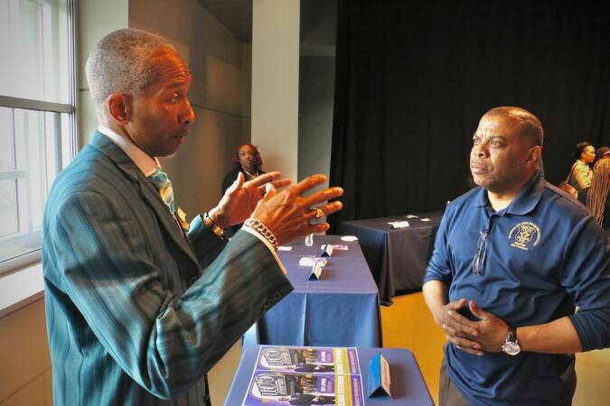 Philadelphia City Council candidate George Stevenson (left) talks with voters at a candidate convention hosted by WHYY. (Emma Lee/WHYY)