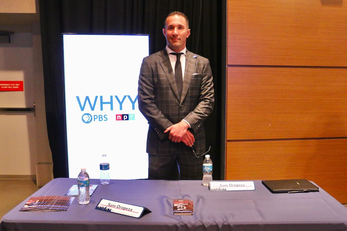 Philadelphia City Council candidate Sam Oropeza talks with voters at a candidate convention hosted by WHYY. (Emma Lee/WHYY)