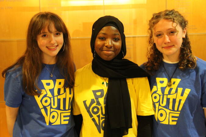 Three people pose for a photo.