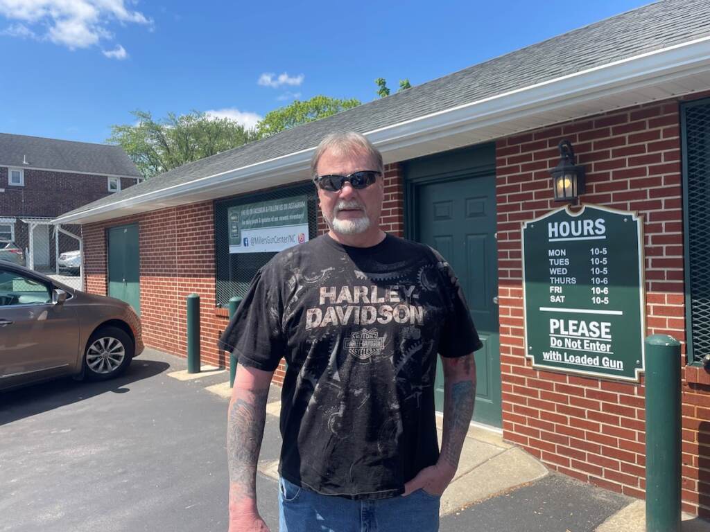 Richard Hines poses in front of a brick building.