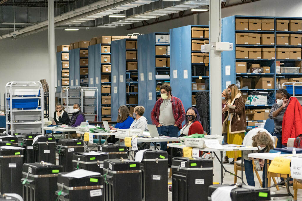 Gwinnett County election workers prepare to handle ballots as part of the recount for the 2020 presidential election on Nov. 16, 2020, in Lawrenceville, Georgia. Nearly two and a half years after the election, voting machine companies, election workers and even a local postmaster have filed defamation cases tied to conspiracy theories that have spread about the election. Gwinnett County election workers prepare to handle ballots as part of the recount for the 2020 presidential election on Nov. 16, 2020, in Lawrenceville, Georgia. Nearly two and a half years after the election, voting machine companies, election workers and even a local postmaster have filed defamation cases tied to conspiracy theories that have spread about the election.