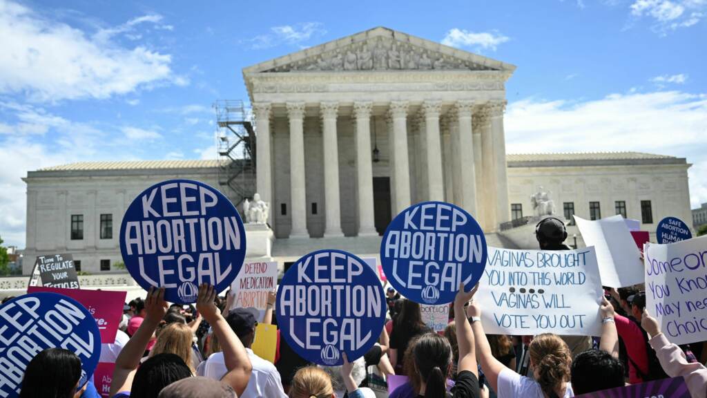 Demonstrators rally in support of abortion rights at the Supreme Court in Washington, D.C., on Saturday. People hold signs reading keep abortion legal outside of the Supreme Court.