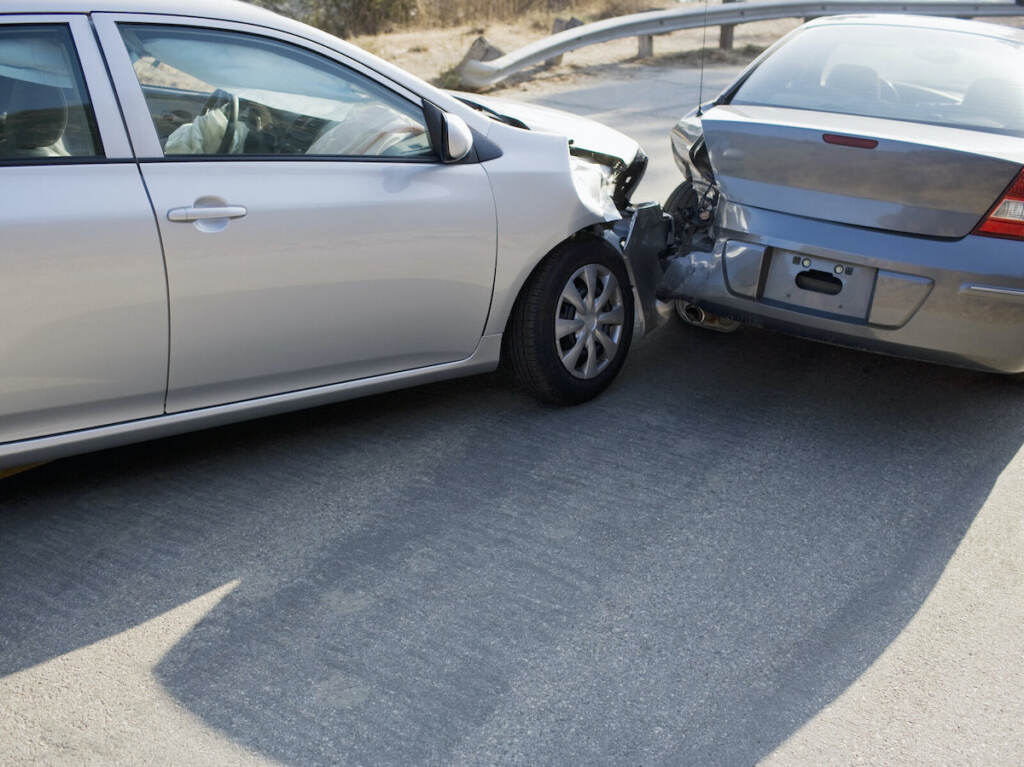 Two cars in collision on roadway Rear End Car Collision