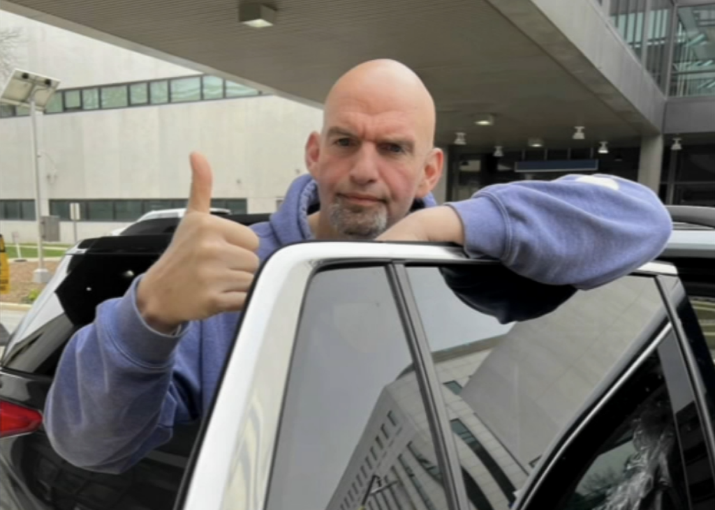 john-fetterman-leaves-hospital-6abc-2023-04-17 John Fetterman gives a thumbs up while getting into a car.