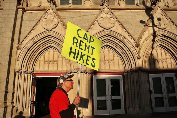 A man holds a sign that reads 
