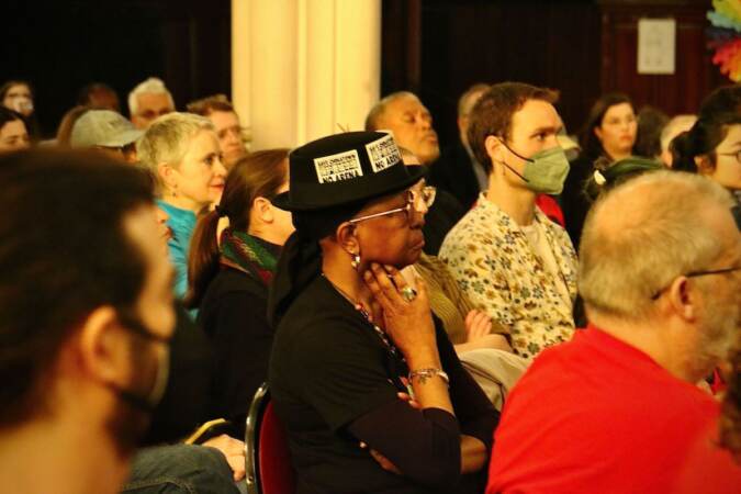 Asantewaa Nkrumah-Ture of the Philadelphia Tennants Union attends the mayoral forum on housing and development wearing a ‘’Save Chinatown’’ hat.