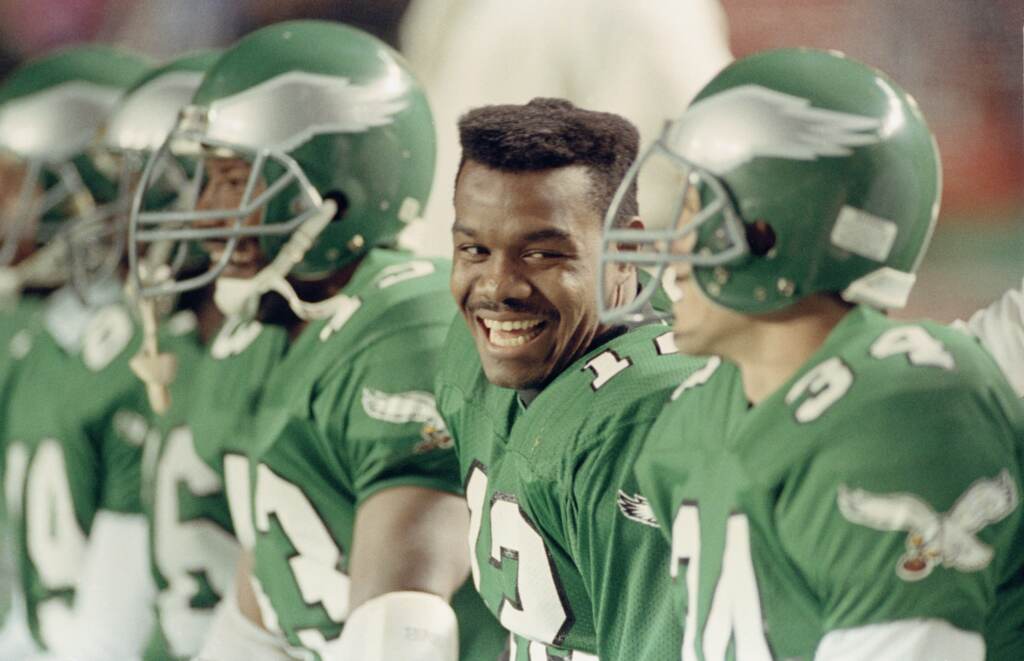 Quarterback Randall Cunningham laughs with teammates on the bench in the closing minutes of the Eagles 28-14 win over the Washington on Nov. 13, 1990, at Veterans Stadium