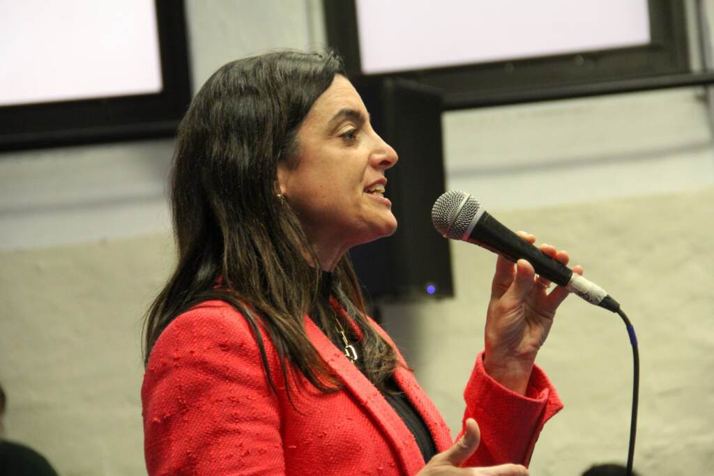 rhynhart-forum-scaled Rebecca Rhynhart speaking into a microphone