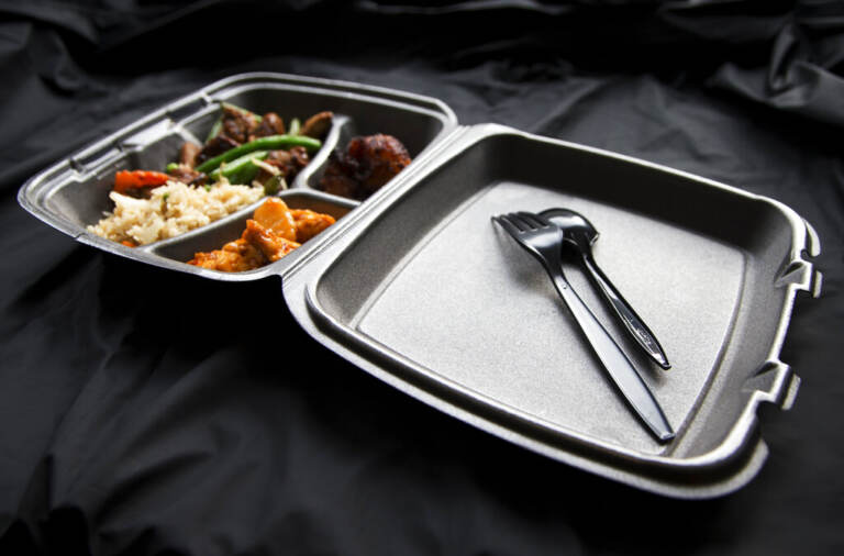 A view of food in a styrofoam cotnainer.