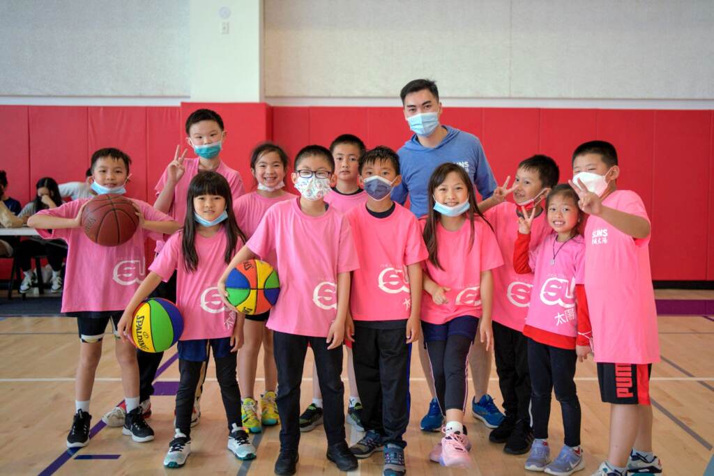 A group of young Suns basketball players with their coach.