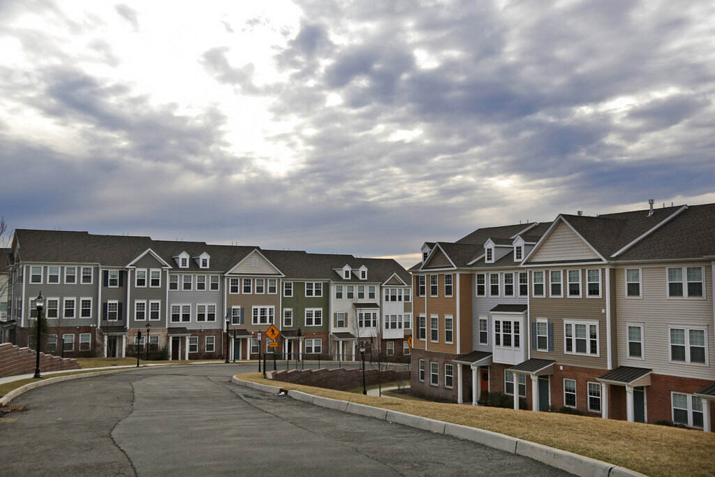 Struggling in a Strong Economy Townhouses in a cul-de-sac are visible.