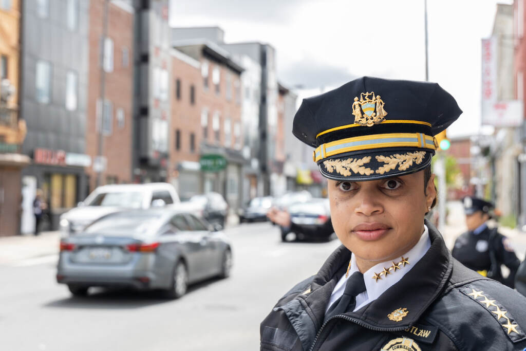 05 04 2023 k paynter candid portrait PPD commissioner danielle outlaw 22nd district tour-2 Philadelphia Police Commissioner Danielle Outlaw is shown up close, with a city block and street visible behind her.