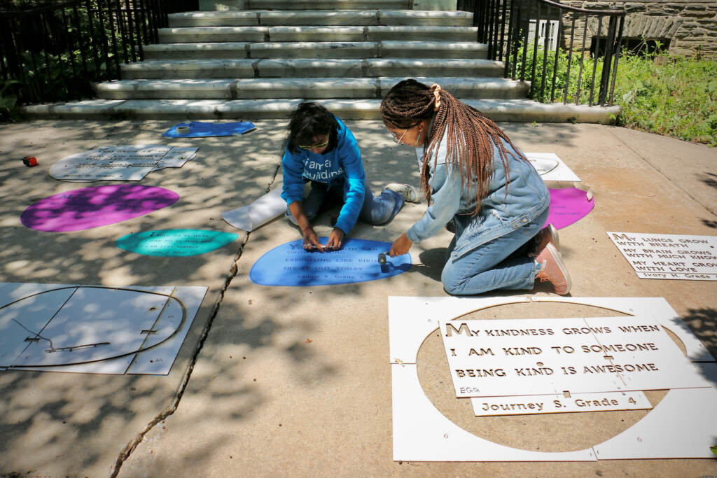 2023 05 19-e lee-anshika lal caprice jackson-philadelphia germantown vernon park-rain poetry permanent poem Anshika Lal and Caprice Jackson installing the exhibit