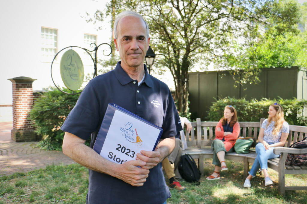 Geoffrey Berwind holds a binder while posing for a photo.