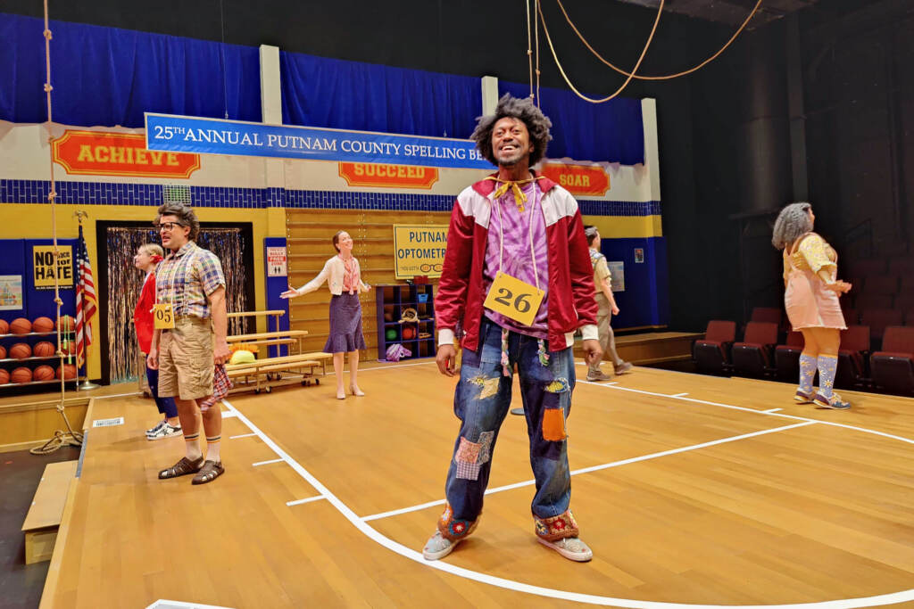 2023 05 26-p crimmins-garrick vaughan-philadelphia arden theatre-spelling bee play Garrick Vaughn sings with other performs onstage.