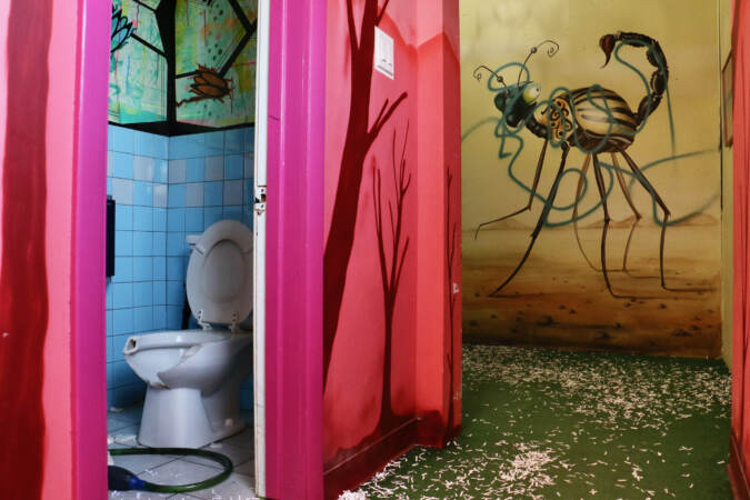 A smashed toilet is visible.