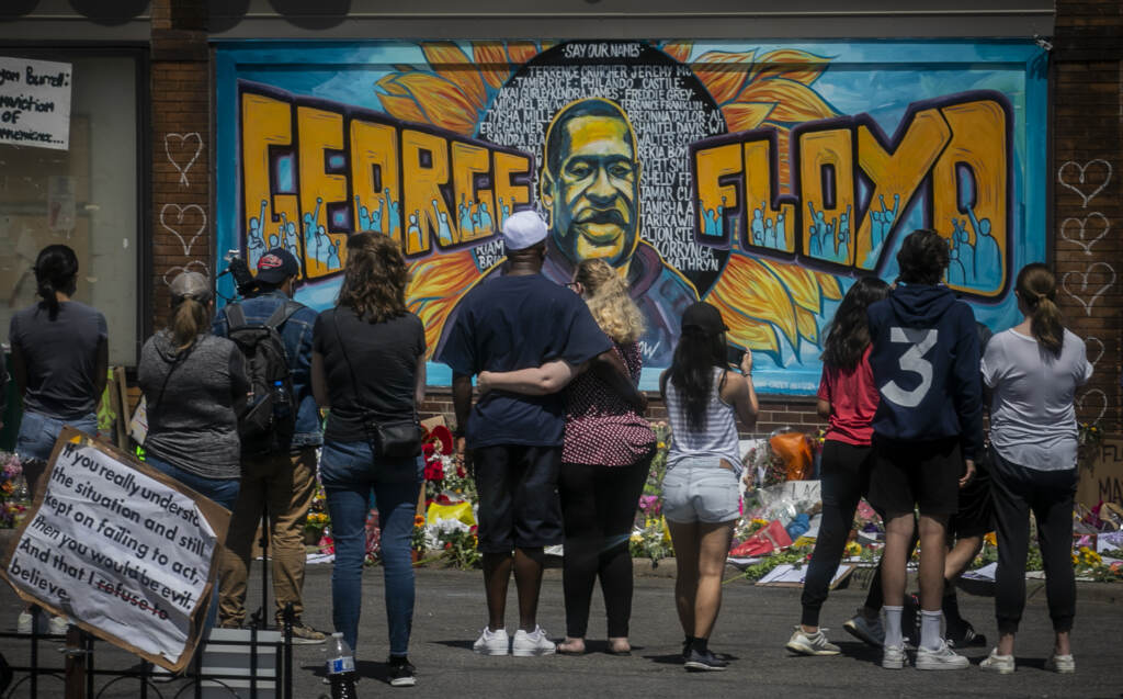 George Floyd Minneapolis Police In this May 31, 2020 file photo, visitors make silent visits to organic memorial featuring a mural of George Floyd, near the spot where he died while in police custody, in Minneapolis