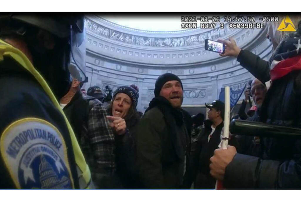 Capitol Riot Justice Investigation File photo: This image from Metropolitan Police Department body worn camera video and contained in the Statement of Facts supporting an arrest warrant for Pauline Bauer, pointing second to left, taken in the Rotunda of the U.S. Capitol on Jan. 6, 2021, in Washington. (Justice Department via AP)