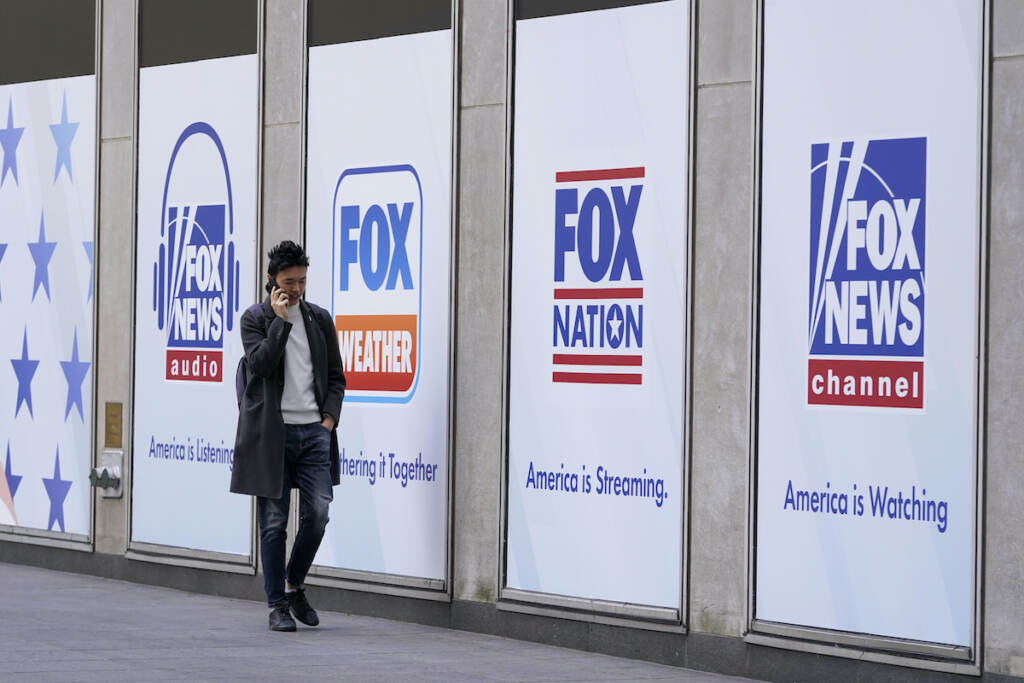 Fox Dominion Lawsuit A man walks past the News Corp. and Fox News headquarters on Wednesday, April 19, 2023, in New York. Fox Corp.'s hefty $787.5 million settlement with Dominion over defamation charges is unlikely to make a dent in Fox's operations, analysts say. (AP Photo/Mary Altaffer, File)