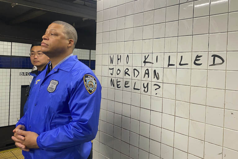 Police officers watch as protesters gather in the Broadway-Lafayette subway station to protest the death of Jordan Neely, Wednesday, May 3, 2023 in New York. Four people were arrested, police said. Neely, a man who was suffering an apparent mental health episode aboard a New York City subway, died this week after being placed in a headlock by a fellow rider on Monday, May 1, according to police officials and video of the encounter. 
(AP Photo/Jake Offenhartz)