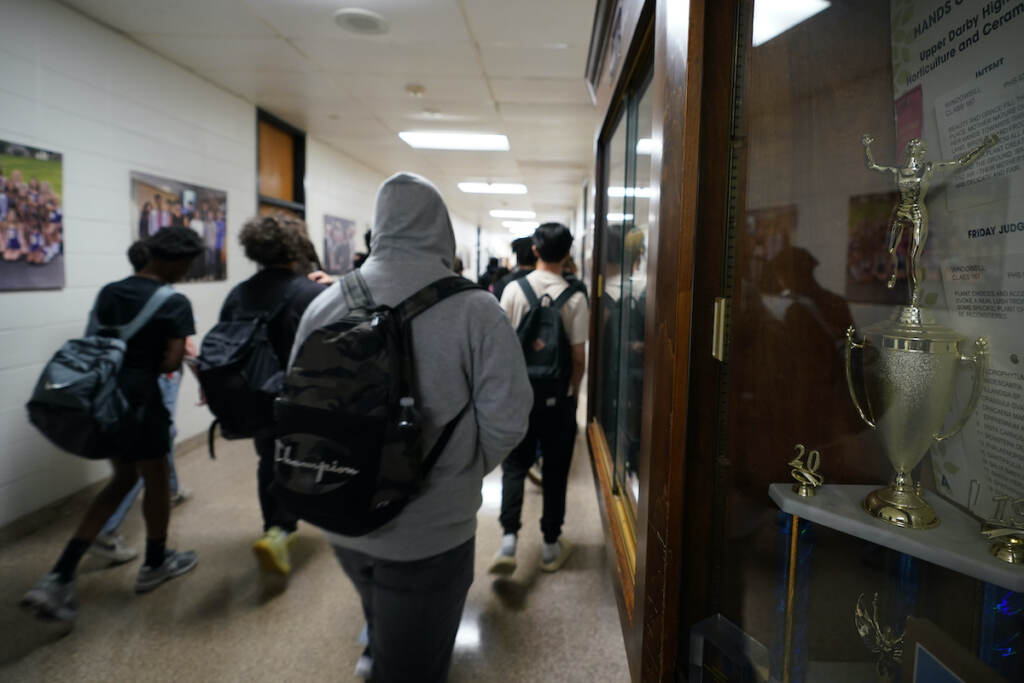 School Start Times Students walking in the hall at school.