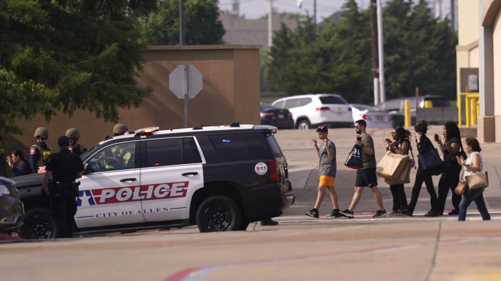 APTOPIX Mall Shooting Texas People raise their hands as they leave a shopping center following reports of a shooting, Saturday, May 6, 2023, in Allen, Texas.