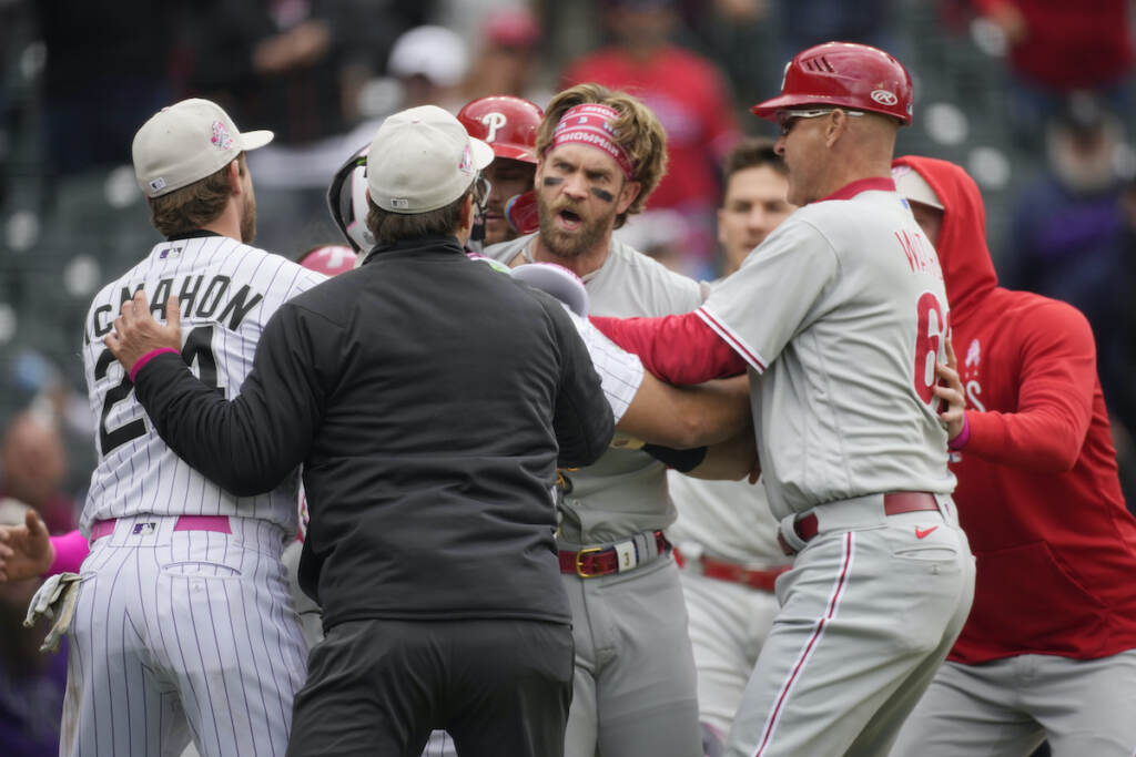 Phillies Rockies Baseball Philadelphia Phillies designated hitter Bryce Harper, back center, is held back from pursuing Colorado Rockies relief pitcher Jake Bird by, from front left, Colorado's Ryan McMahon, first base umpire Ben May and Philadelphia third base coach Dusty Wathan in the seventh inning of a baseball game, Sunday, May 14, 2023, in Denver.
(AP Photo/David Zalubowski)