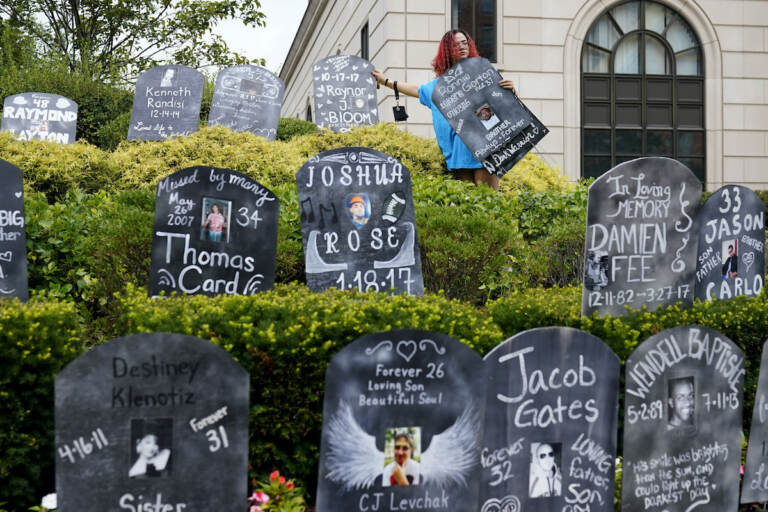 Jayde Newton helps to set up cardboard gravestones with the names of victims of opioid abuse outside the courthouse where the Purdue Pharma bankruptcy is taking place in White Plains, N.Y., on Aug. 9, 2021. A three-judge panel of the 2nd U.S. Circuit Court of Appeals in New York on Tuesday, May 30 overturned a lower court’s 2021 ruling that found bankruptcy courts did not have the authority to protect members of the Sackler family who own the company and who have not filed for bankruptcy protection from lawsuits