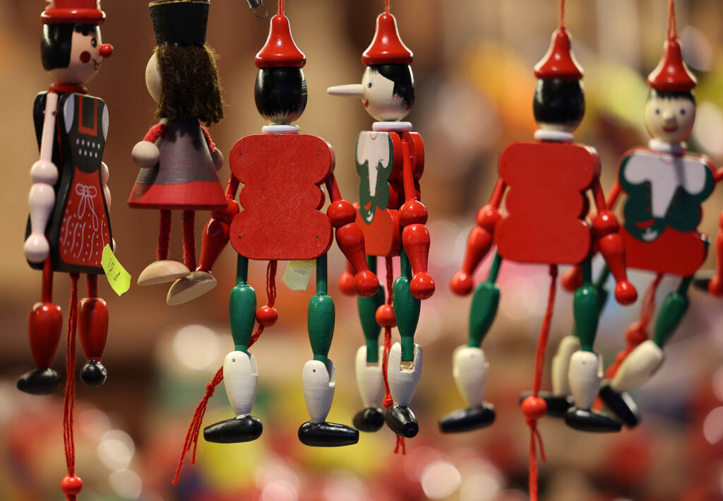 Cracow, Poland – December 19, 2021:traditional Wooden Pinocchio Pinocchio toy sold in souvenir shop in Cracow.