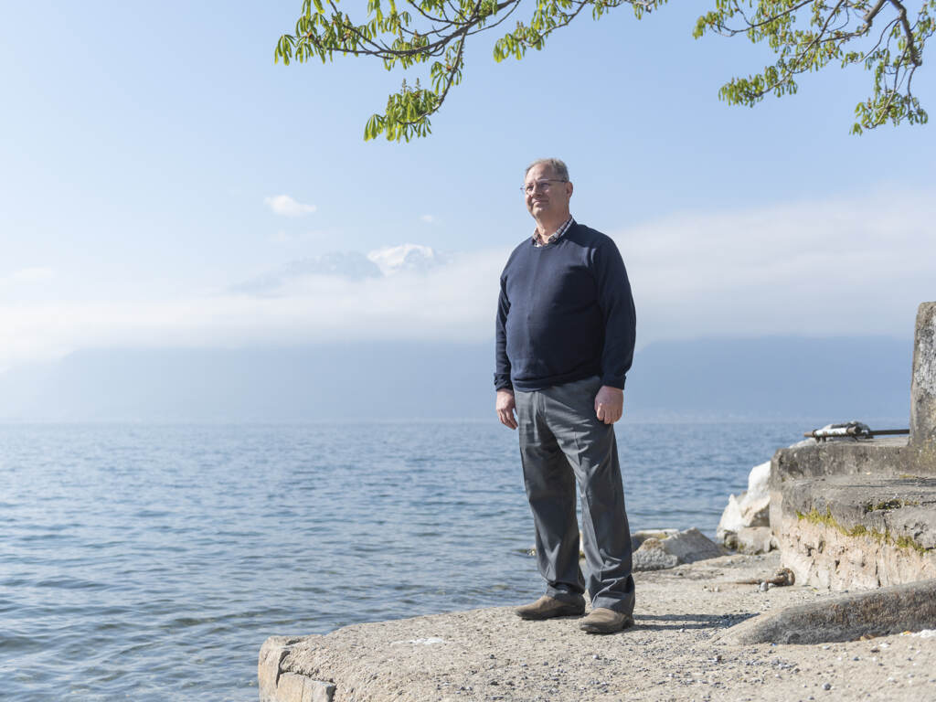 After emergency surgery, an American expatriate with Swiss insurance now carries the baggage of a five-figure bill. Jay Comfort standing on a cliff overlooking the ocean.