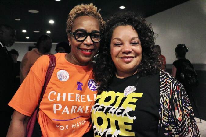Dr. Argie Allen-Wilson (left), cofounder of Mental Health First Connects, and Catherine Hicks, publisher of the Philadelphia Sunday Sun and president of the Philadelphia NAACP, celebrate Cherelle Parker’s victory in the Democratic mayoral primary at Laborers Local 332 headquarters. (Emma Lee/WHYY)