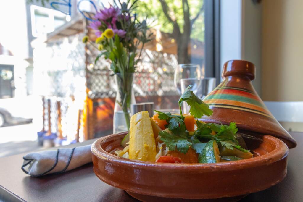 chezhansi-tajine-scaled A view of a bright, colorful vegetable tajine dish on a table.