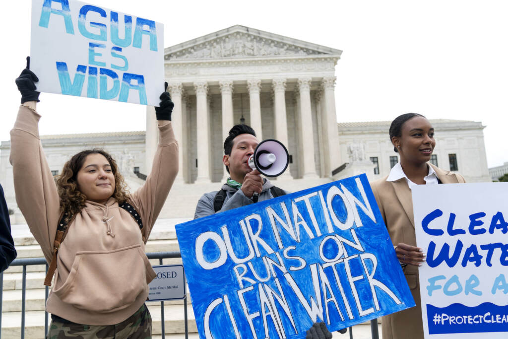 Bethsaida Sigaran, Jaime Sigaran, Thea Louis Clean Water Act supporters protest outside the Supreme Court