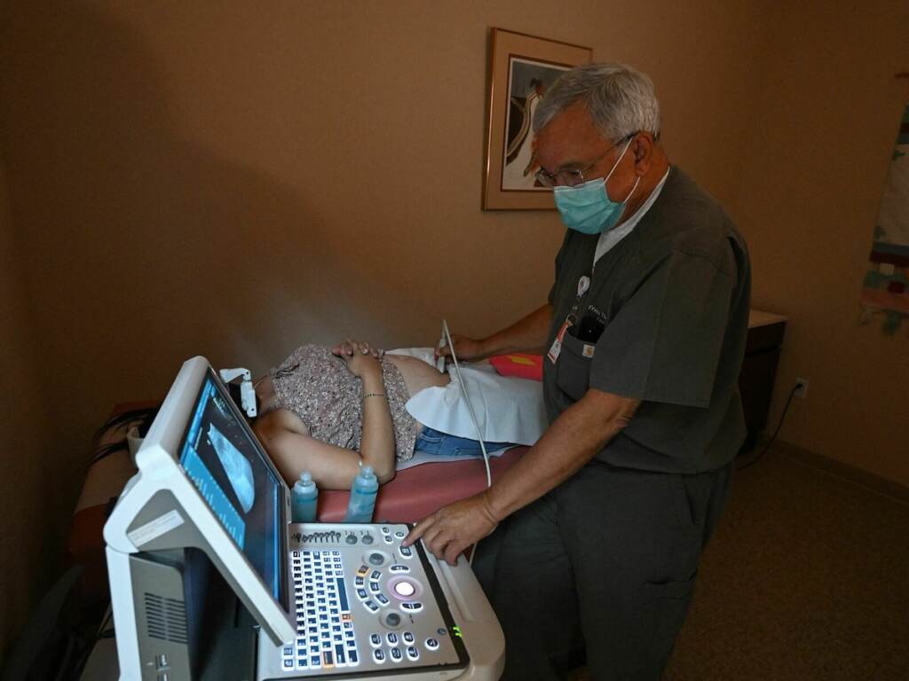 US-ABORTION-TEXAS-NEWMEXICO-CLINIC Dr Franz Theard performs a sonogram to confirm pregnancy on a patient seeking abortion services at the Women's Reproductive Clinic, which provides legal medication abortion services, in Santa Teresa, New Mexico, on June 15, 2022. - In the wake of Friday's ruling by the US Supreme Court striking down Roe v Wade and the federally protected right to an abortion, women from Texas and other states are traveling to clinics like the Women's Reproductive Health Clinic in New Mexico for legal abortion services under the state's more liberal laws. - RESTRICTED TO EDITORIAL USE (Photo by Robyn Beck / AFP) / RESTRICTED TO EDITORIAL USE (Photo by ROBYN BECK/AFP via Getty Images)