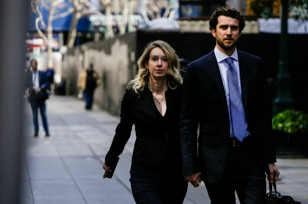 Former Theranos CEO Elizabeth Holmes alongside her partner Billy Evans, walks back to her hotel following a hearing at the Robert E. Peckham U.S. Courthouse on March 17, 2023 in San Jose, Calif. Holmes is set to start her 11-year prison sentence on Tuesday. Former Theranos CEO Elizabeth Holmes alongside her partner Billy Evans, walks back to her hotel following a hearing at the Robert E. Peckham U.S. Courthouse on March 17, 2023 in San Jose, Calif. Holmes is set to start her 11-year prison sentence on Tuesday.