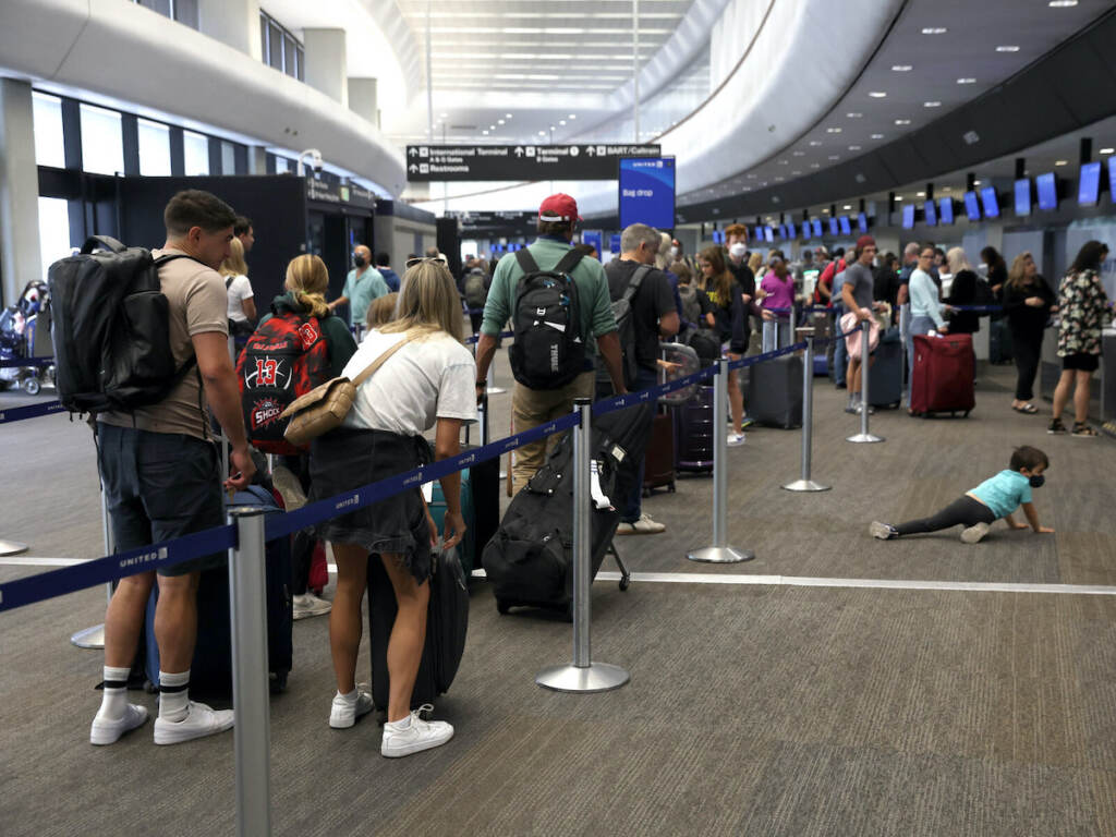 Delays And Cancellations Continue To Plague Airline Industry Heading Into Holiday Weekend SAN FRANCISCO, CALIFORNIA - JULY 01: Travelers line up to check in for United Airlines flights at San Francisco International Airport on July 01, 2022 in San Francisco, California. According to AAA, nearly 48 million Americans are expected to hit the road for the Fourth of July holiday weekend and will travel more than 50 miles away from their home. It will be the second busiest July 4 travel weekend since 2000. (Photo by Justin Sullivan/Getty Images)