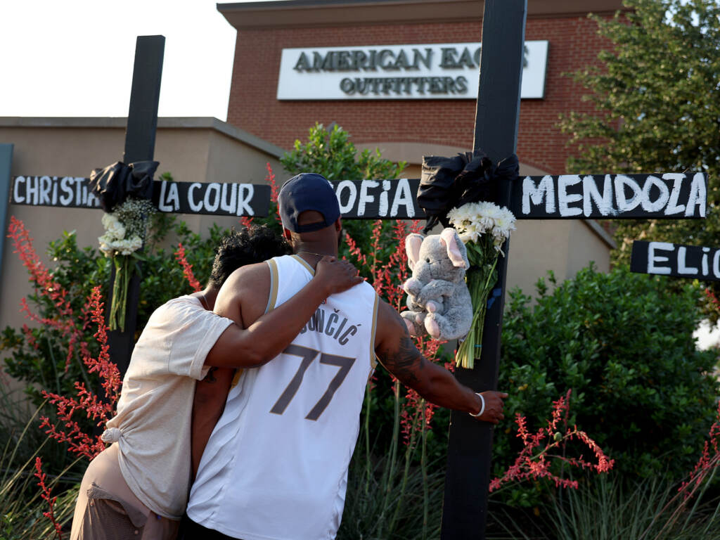 Robert Jackson and his mother Cheryl Jackson hug as they visit a memorial near the scene of a mass shooting at the Allen Premium Outlets mall on Monday in Allen, Texas. Robert Jackson and his mother Cheryl Jackson hug as they visit a memorial near the scene of a mass shooting at the Allen Premium Outlets mall on Monday in Allen, Texas.