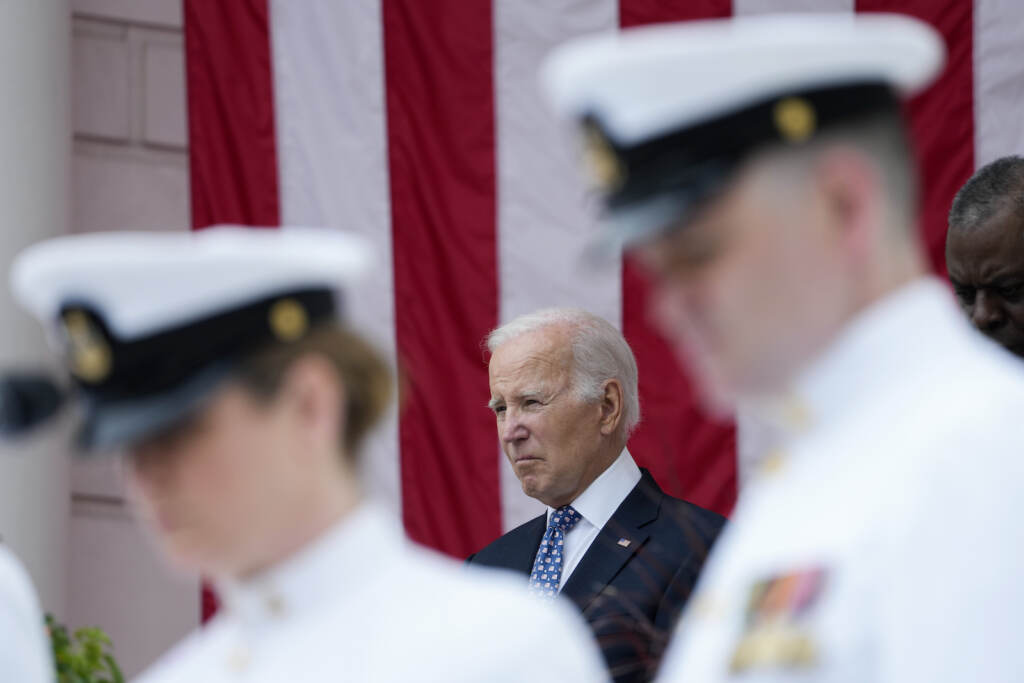 Joe Biden, Lloyd Austin President Joe Biden stands with Defense Secretary Lloyd Austin as the national anthem is played at the Memorial Amphitheater of Arlington National Cemetery