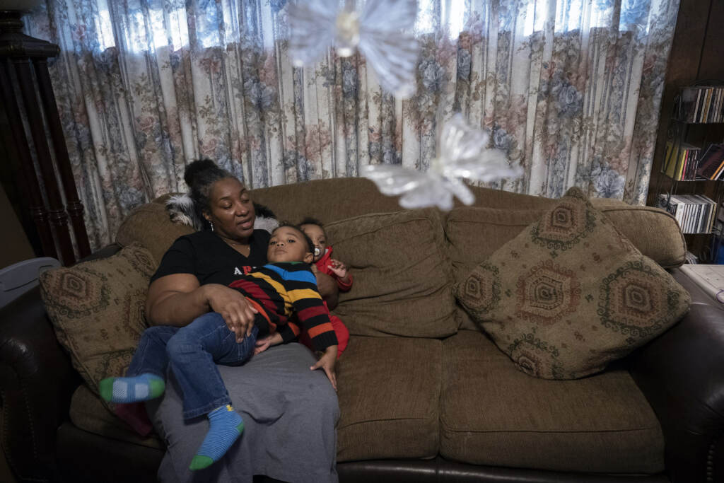 Shelonda Lyons on the couch with her grandchildren