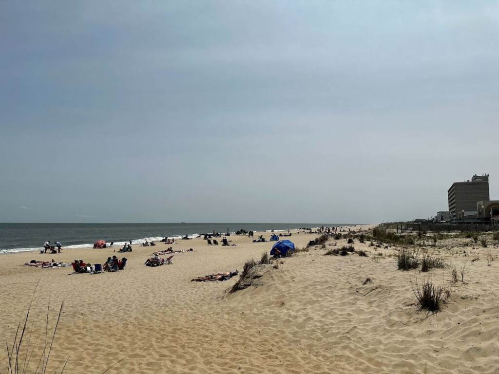 People sunbathe on the sand at Rehoboth Beach.
