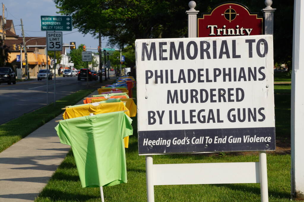 trinity-evangelical-lutheran-church-lansdale-2023-05-22-s-searles-heeding4 t shirt memorial on a lawn showing names of people killed