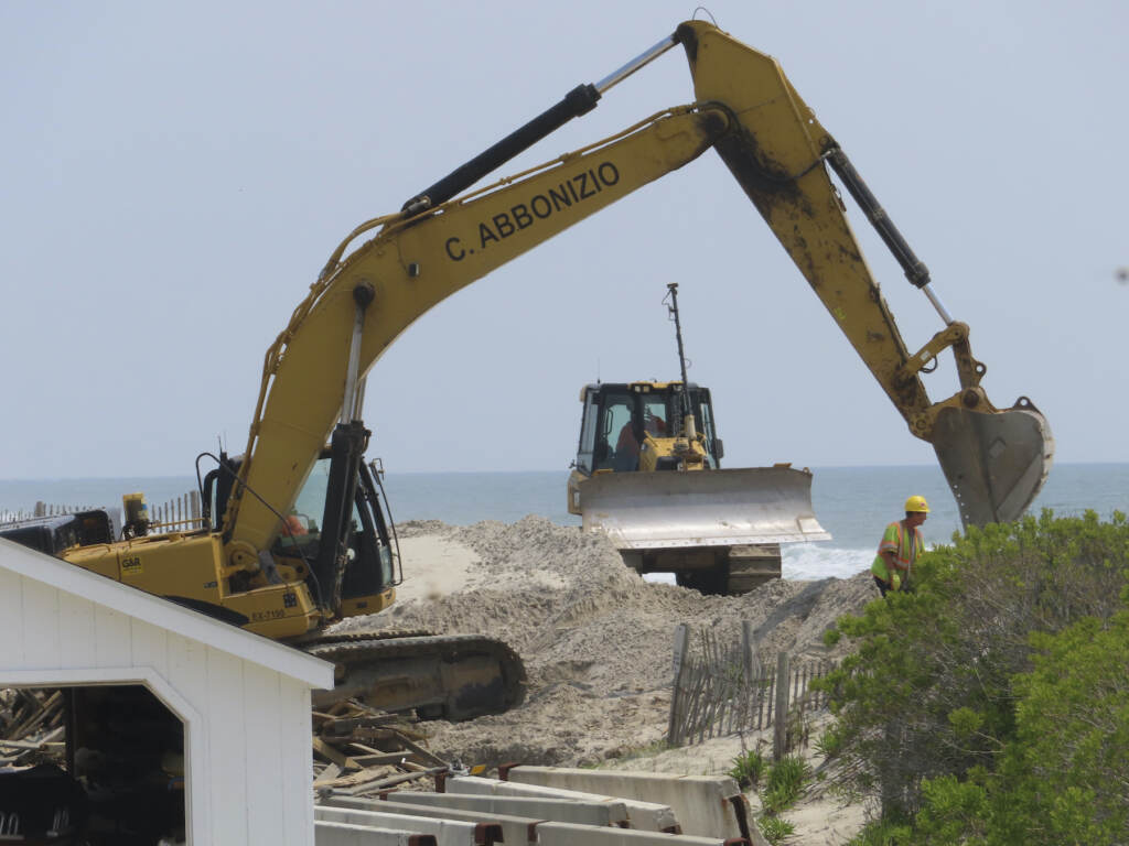 Defiant Beach Town A bulldozer repairs a sand dune