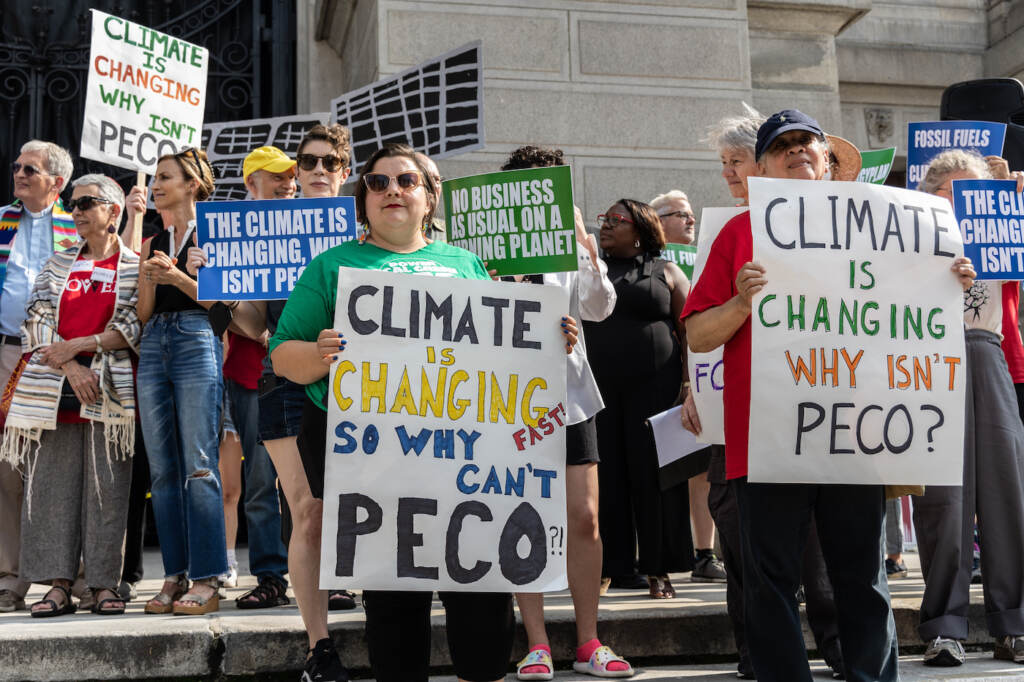 06 28 2023 k paynter POWER People’s energy plan rally Multiple protesters holding signs about climate change and PECO.