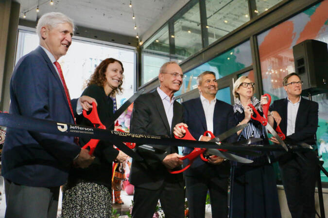 Cutting the ribbon to open Jefferson Plaza are (from left) Paul Levy of Center City District, Jane Golden of Mural Arts Philadelphia, Jeffrey Kanne of National Real Estate Advisors, Joseph Cacchione and Patricial Wellenbach, of Thomas Jefferson University and Jefferson Health, and Daniel Killinger of National Real Estate Development. (Emma Lee/WHYY)